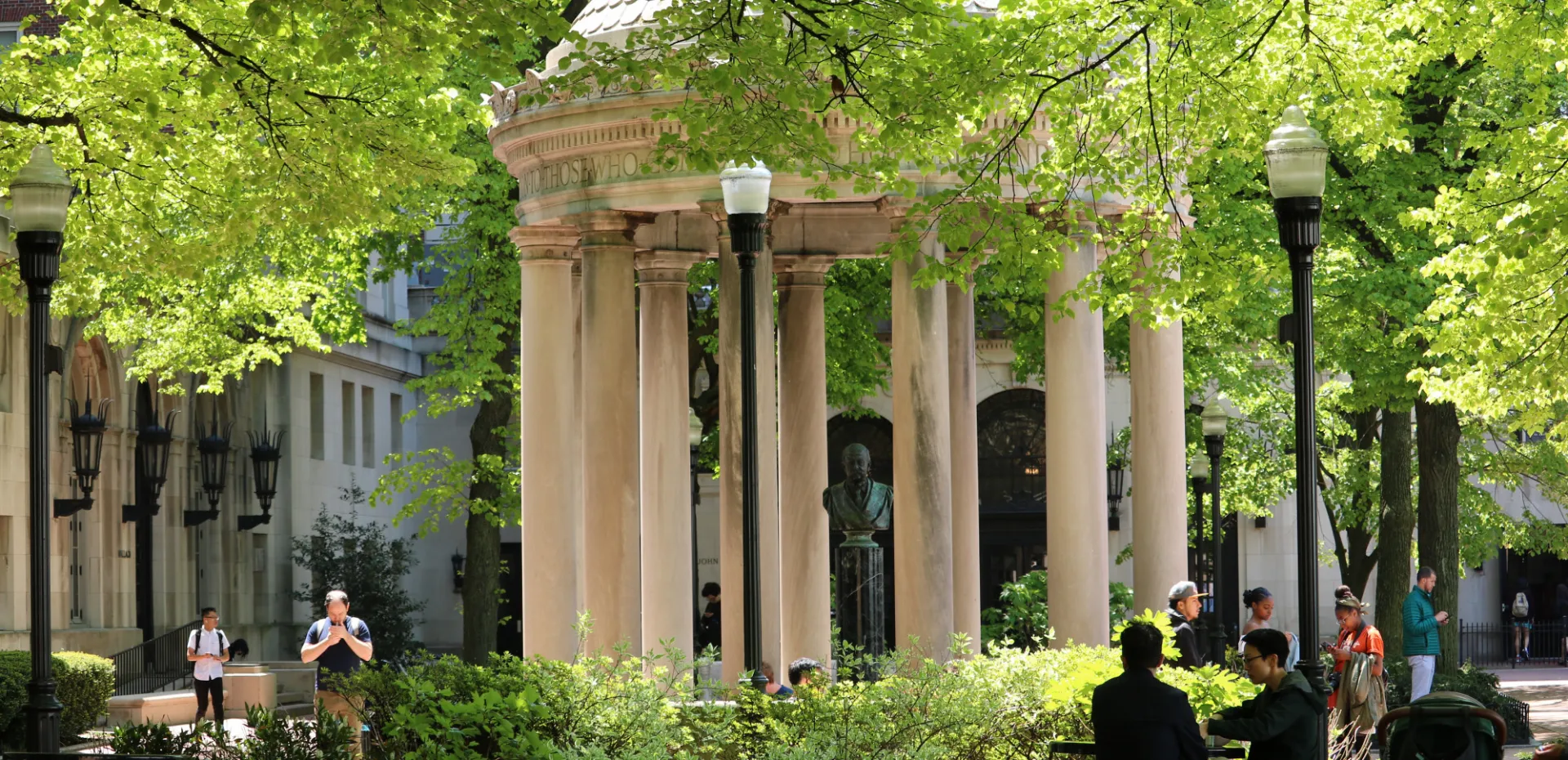 Students walk to class through the Van Amringe Quadrangle on a sunny day.
