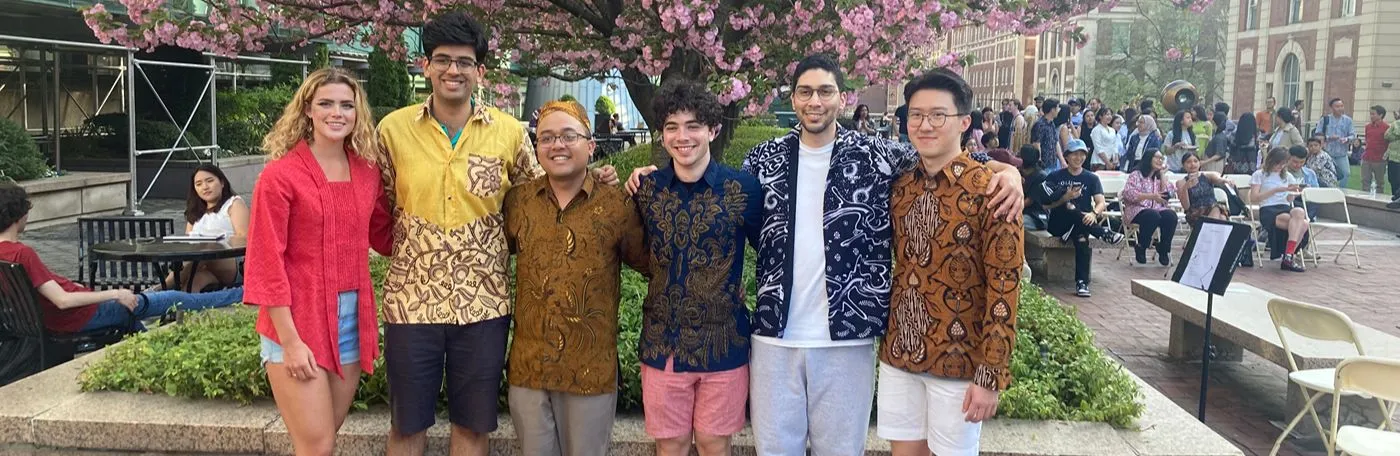 Students of Indonesian celebrating Indonesian Culture Day in front of a flowering tree