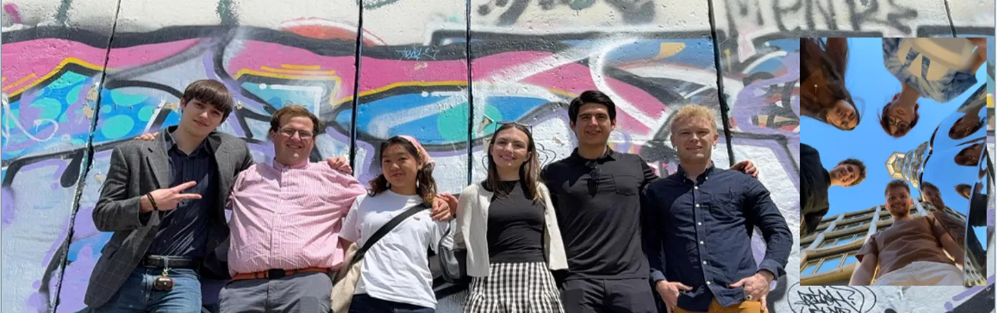 A group of six young adults poses together outdoors in front of a colorful graffiti wall. On the far right, a small inset photo shows a low-angle view looking up at several people standing in a circle against a blue sky next to a building and reflection sphere.